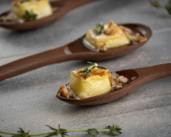 cuillère en bois contenant du fromage fondu